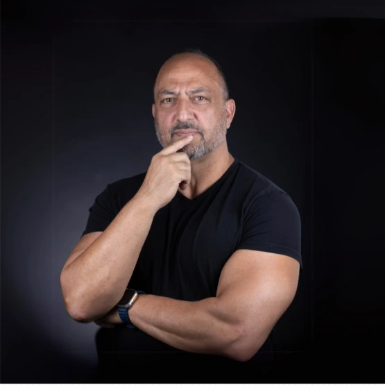 Ian Hill headshot with black tshirt and black background